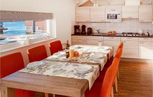 a kitchen with a table with chairs and a tableablish at Maasvilla - Amfibie - 31 in Ohé en Laak