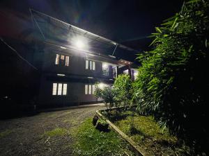 a building with a light on the side of it at night at D Villas in Kunnamangalam