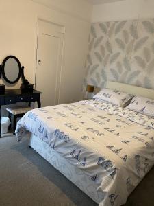 a bedroom with a bed with a white comforter at The Rosefield in Weymouth