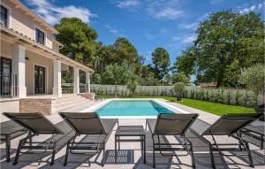 a patio with chairs and a swimming pool at 5 Bedroom Nice Home In Manjadvorci in Manjadvorci