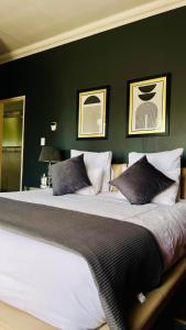 a large bed in a bedroom with green walls at The Private Place in eMalahleni