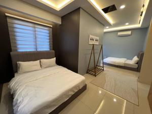 a bedroom with a bed and a couch in it at RUMAH SAUJANA KLIA by IMPIAN HOMESTAY in Sepang