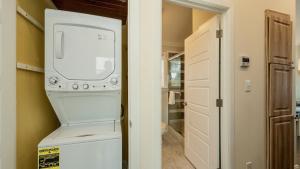 a laundry room with a washer and dryer next to a door at Carefree on Cudjoe by Last Key Realty in Cudjoe Key