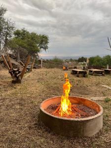 a fire pit in the middle of a field at Montecielo in San Antonio de Arredondo
