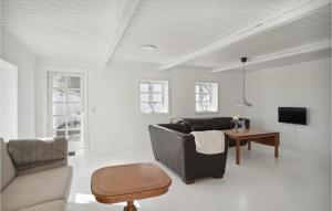 a living room with a couch and a table at Nice Apartment In Gandrup With Kitchen in Gandrup