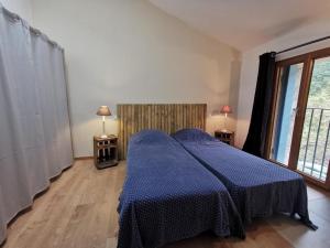 Postel nebo postele na pokoji v ubytování GÎTE 3* SAINT GUILHEM LE DESERT CHEZ MARIUS