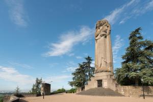 a tall stone monument in a park with trees at Studio Moderne et Cosy à Miribel in Miribel +2 photos