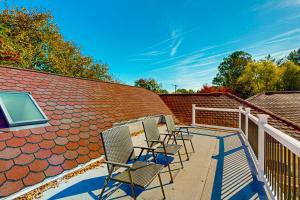 three chairs on a balcony with a roof at Town of Ocean View --- 8 Elliott Ave in Bethany Beach