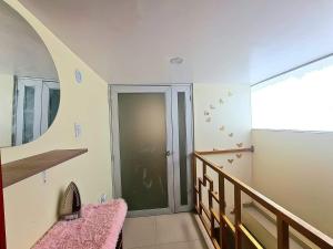 a room with a staircase with a door and a stair case at Quechua hospedaje in Huaraz +3 photos