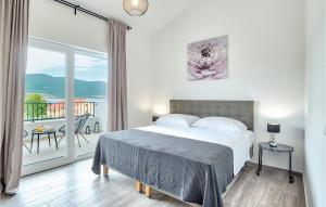 a bedroom with a bed and a balcony at Villa Ena Mar in Zadar