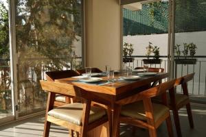 a dining room table with chairs and a table and a window at Aqua Reef Condos Sayulita, Apt 1 in Sayulita