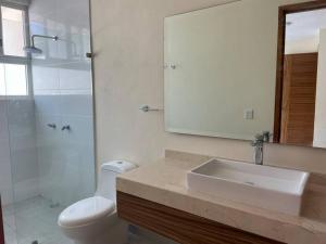 a bathroom with a sink and a toilet and a mirror at Aqua Reef Condos Sayulita, Apt 1 in Sayulita +21 photos