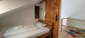 - une chambre avec un lit et une porte en bois dans l'établissement Lieblingsort am Moor, à Gnarrenburg