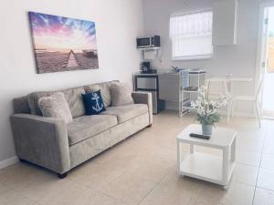 a living room with a couch and a table at Coastal Cabana in Hollywood