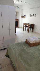 a room with a bed and a table in it at Departamento equipado, centrico, cochera cubierta Sarmiento265apart D18 in San Fernando del Valle de Catamarca