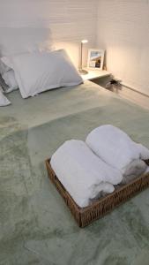 a bed with two white towels on top of it at Departamento equipado, centrico, cochera cubierta Sarmiento265apart D18 in San Fernando del Valle de Catamarca