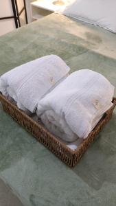 two towels are sitting on a tray on a bed at Departamento equipado, centrico, cochera cubierta Sarmiento265apart D18 in San Fernando del Valle de Catamarca +41 photos