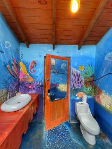 a bathroom with a fish mural on the wall at Ekhotel & Glamping en Punta Cana in Suero