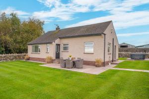 a house with a lawn in front of it at Colt Park Cottage in Ulverston