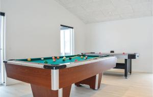 a pool table with balls on it in a room at Four-Bedroom Holiday Home In Ringkobing in Ringkøbing