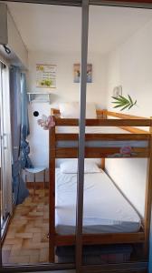 a bedroom with two bunk beds in a room at Studio Plage 200m Parking gratuit Port la Nouvelle in Port-la-Nouvelle