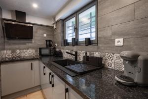 a kitchen with a sink and a counter top at Suite avec jacuzzi proche Paris & Disneyland in Pontault-Combault