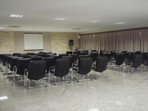 a conference room with black chairs and a whiteboard at Lacqua Park Caldas Novas in Caldas Novas