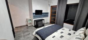 a bedroom with a bed and a fireplace and a television at Jukskei Big 5 - Leopard in Randburg +1 photo