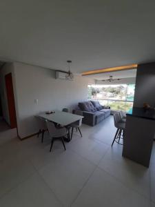 a living room with a table and a couch at Meu lar na Serra Gaúcha in Nova Petrópolis
