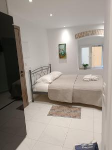 a bedroom with a bed and a mirror on the wall at Tatiana's Town Studio in Corfu