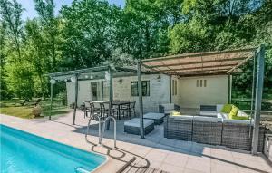 a patio with a table and chairs and a pool at Awesome Home In Vianne in Vianne