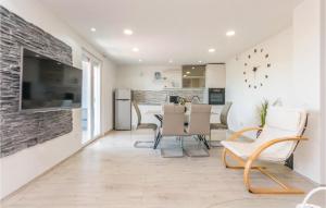 a kitchen and living room with a table and chairs at Lovely Home In Stankovci With Wifi in Stankovci