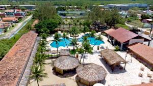 an aerial view of a resort with two pools and umbrellas at Arena Carneiros Hotel by AFT in Tamandaré