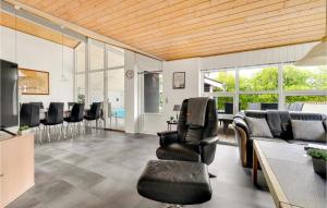 a living room with chairs and a table with a pool at 4 Bedroom Lovely Home In Vestervig in Vestervig