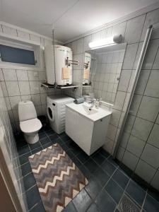 a bathroom with a sink and a toilet at Hoda Apartment - Cozy central apartment with free parking in Leknes +13 photos