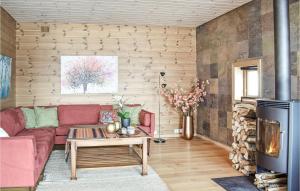 a living room with a red couch and a fireplace at Four-Bedroom Holiday Home In Roldal in Røldal