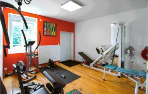 an orange room with a gym with exercise equipment at Beautiful Home In Sauzet in Sauzet