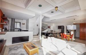 a living room with a white couch and a table at Gorgeous Home In Perpignan in Perpignan