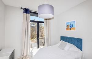 a bedroom with a bed and a window at Gorgeous Home In Perpignan in Perpignan