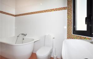 a bathroom with a tub and a toilet and a sink at Gorgeous Home In Perpignan in Perpignan