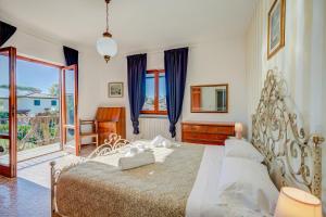 a bedroom with a large bed and a window at Casa Vittoria 800m from sea - Happy Rentals in Forte dei Marmi +19 photos