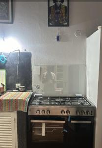 a kitchen with a stove top oven in a kitchen at Dar Massaneh in Essaouira +36 photos