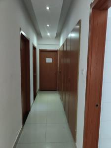 a corridor with wooden doors at Kilamba Apart VP in Camama