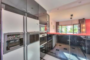 a kitchen with stainless steel appliances and red counters at Residenza Borgo Rustico with Pool - Happy Rentals in Collina d'Oro