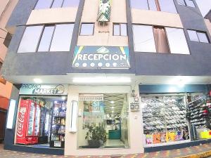 a store front of a building with a store at Hostal Dugan in Baños