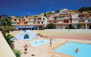 a group of people in a swimming pool at a resort at Bel appartement bord de mer in Cerbère