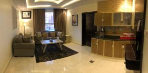 a living room with a couch and a table at فندق جون in Abha