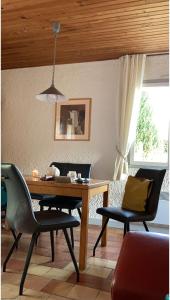 a dining room with a wooden table and chairs at Notre Refuge in Écuras