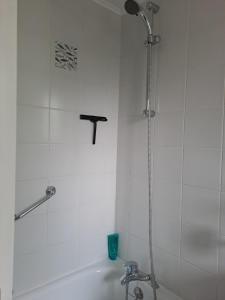 a shower in a white tiled bathroom with a sink at Notre Refuge in Écuras +37 photos