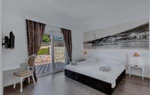 a white bedroom with a bed and a balcony at Villa Prestige in Baška Voda